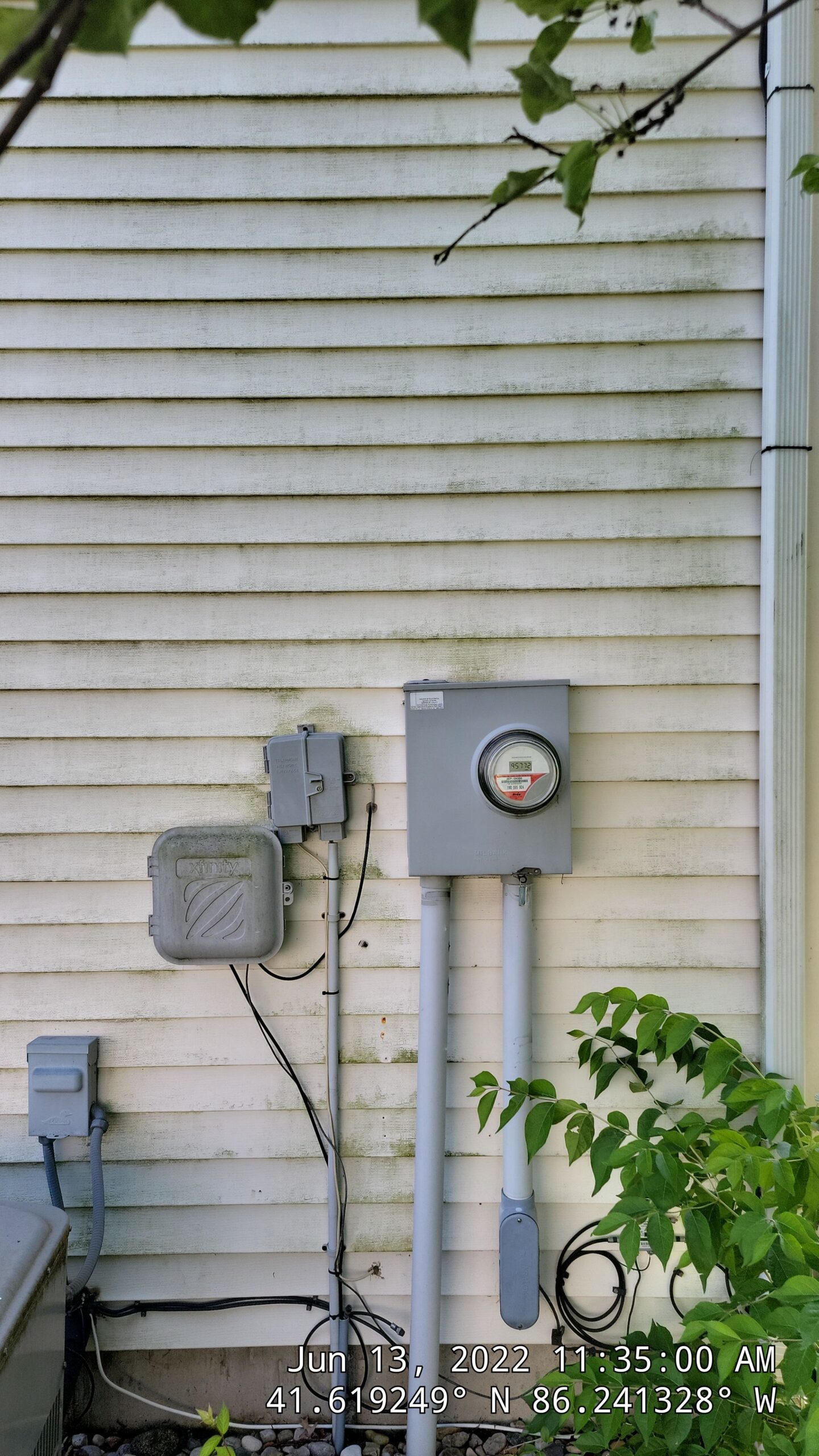 Before — Our Soft Wash Process Safely Eliminates Green Algae Buildup Around Delicate Utility Connections Without Risking Water Damage. — Double A Power Washing