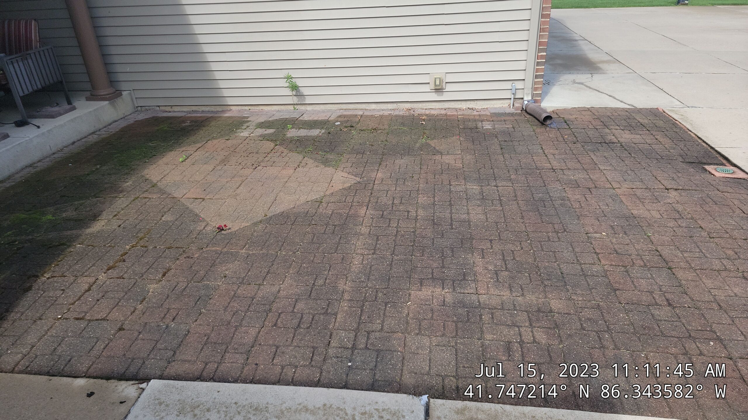 Years Of Organic Growth And Dark Staining On This Brick Paver Patio Are Clearly Visible Before Our Deep Cleaning Process. Concrete And Driveway Cleaning In South Bend, In. Double A Power Washing