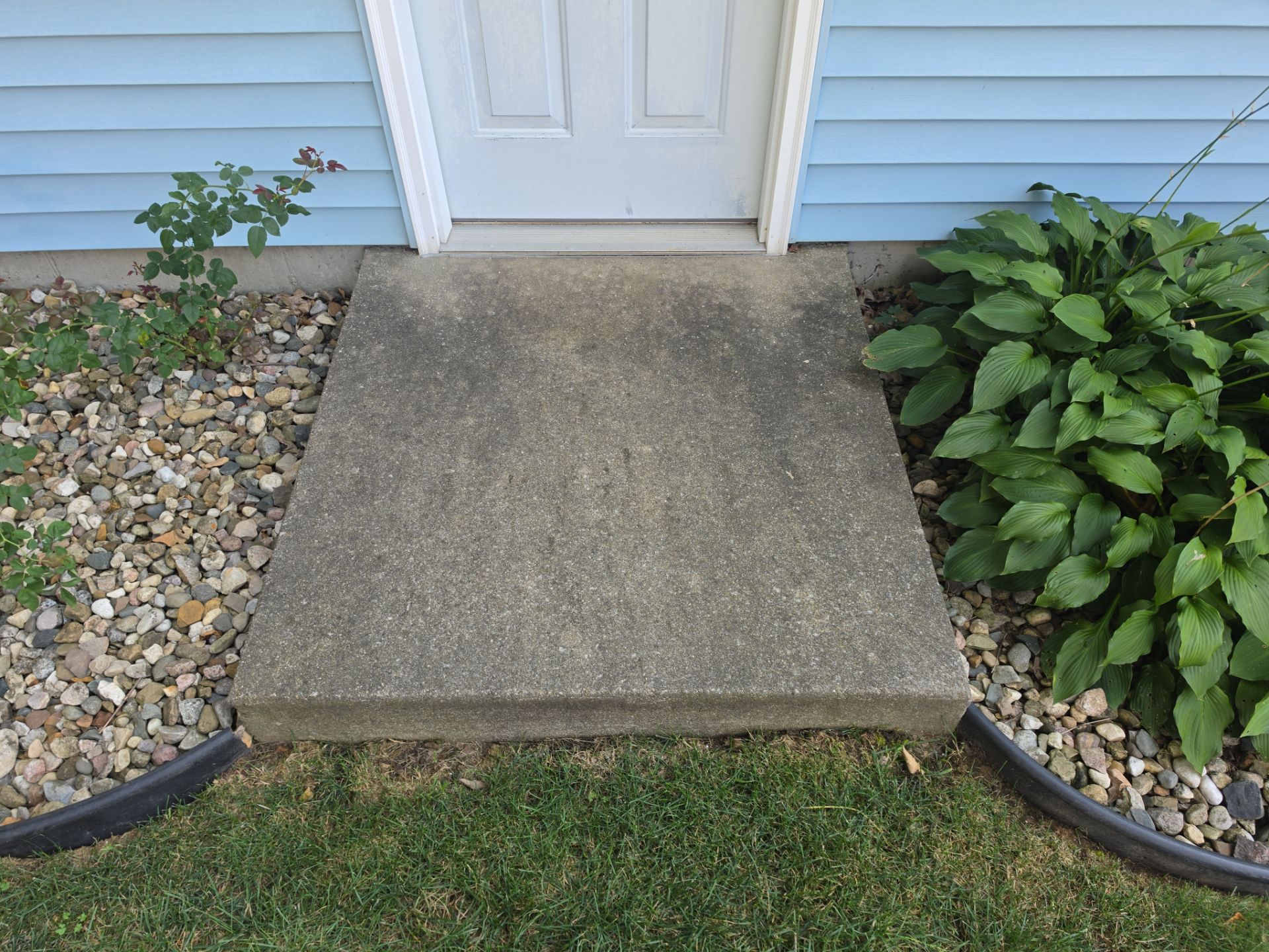This Front Concrete Stoop Showed Heavy Organic Staining Before Professional Surface Cleaning. Concrete And Driveway Cleaning In South Bend, In. Double A Power Washing
